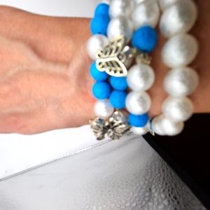 4 bracelets white pearl and blue beads with butterfly pendant. Different style